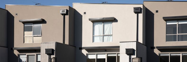 3 terrace houses set against a blue sky