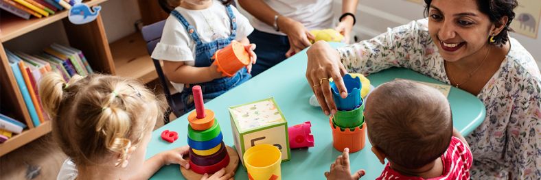 Image of childcare worker with children 