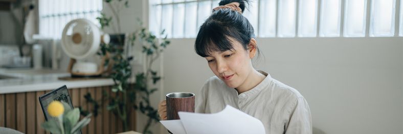 Image of lady looking at piece of paper