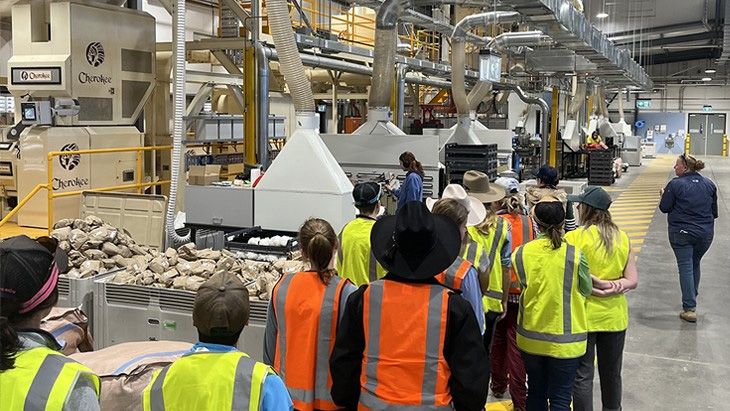 Camp participants on a visit to a factory.