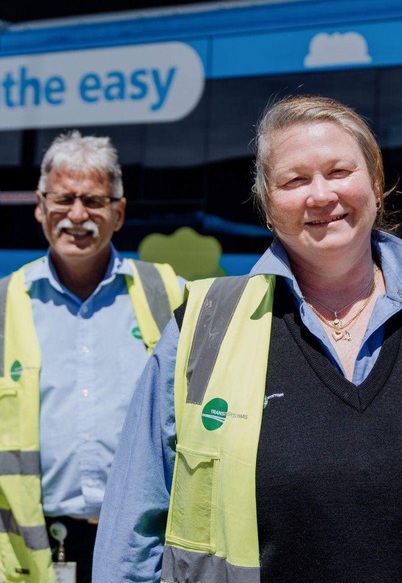 Transport Co-Workers in front of a bus