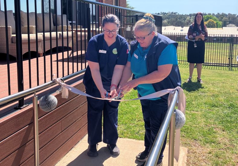 Two Wellington healthcare workers cut the ribbon at the opening of the new palliative care space