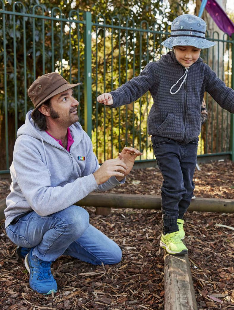 Preschool teacher with children in playground