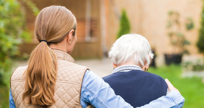 Palliative care volunteer offering support to a patient.