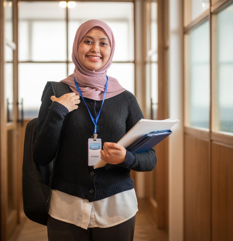 Image of multicultural lady at work hold papers and smiling at the camera