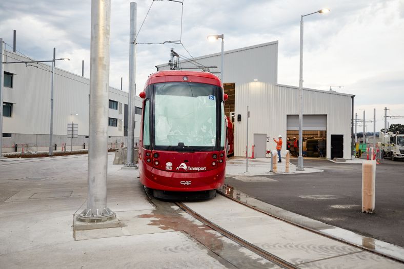 Shot of a tram in the tram wash bay of the stabling and maintenance facility on an overcast day.