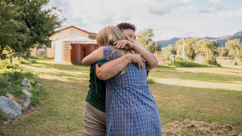 A woman embracing a young person