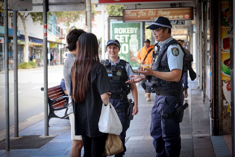 Police officers talking to the public on a footpath