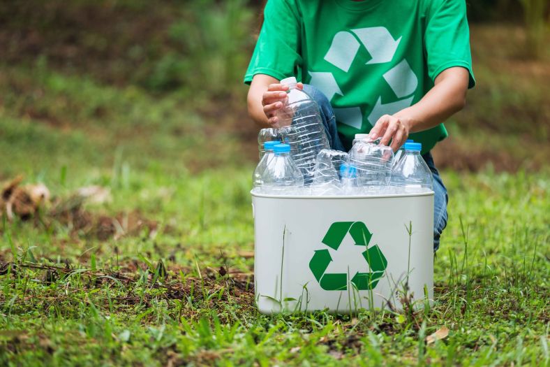 A young person recycling plastics 