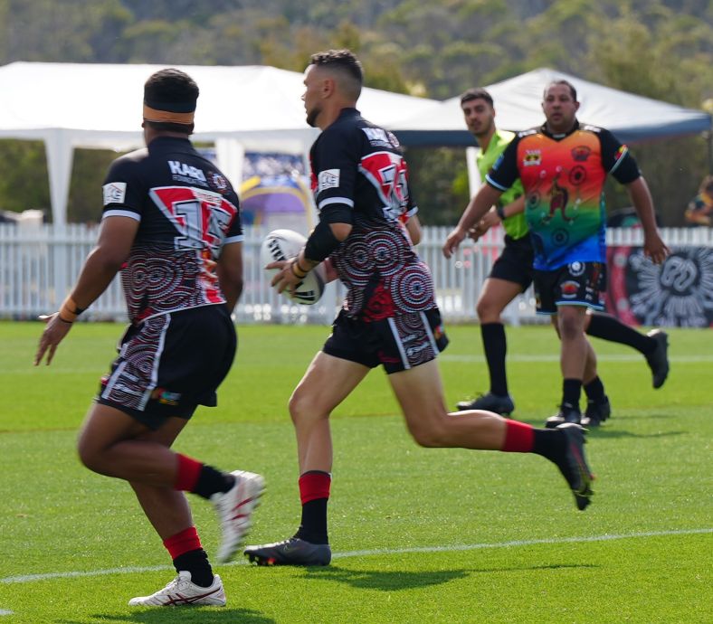Aboriginal football players competing on field