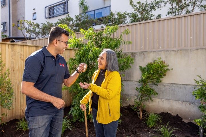 Man handing keys to woman