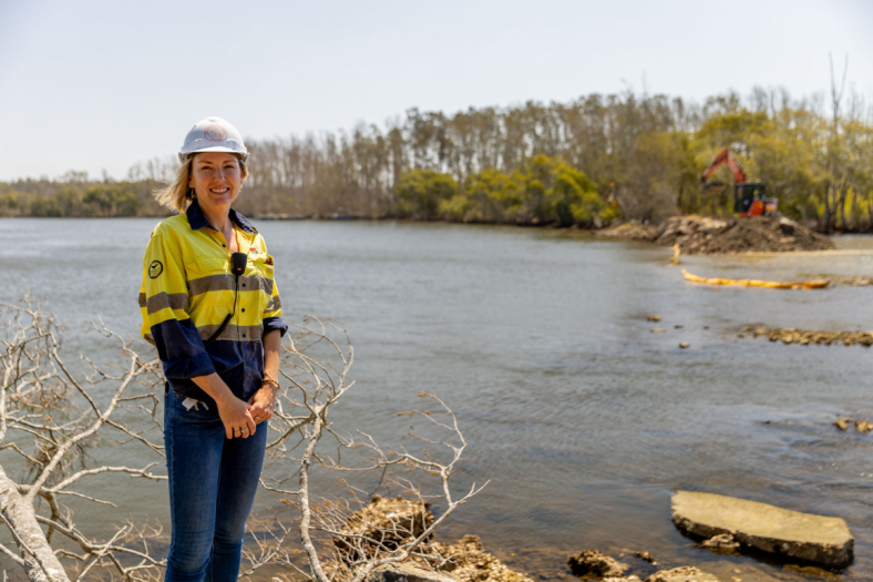A Soil Conservation employee standing in front of river