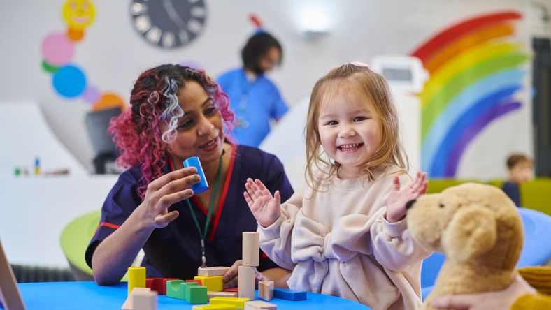 Nurse with patient in children's hospital.