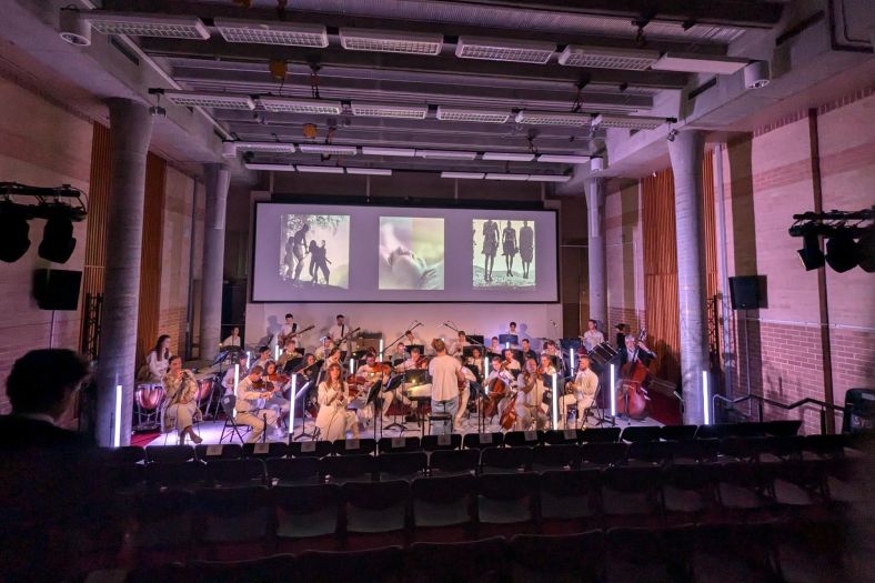 an orchestra rehearsing at Haymarket Creative Main Theatre