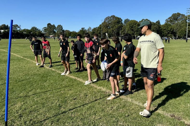 NRL player Latrell Mitchell with young people at a Healthy Lifestyle Clinic