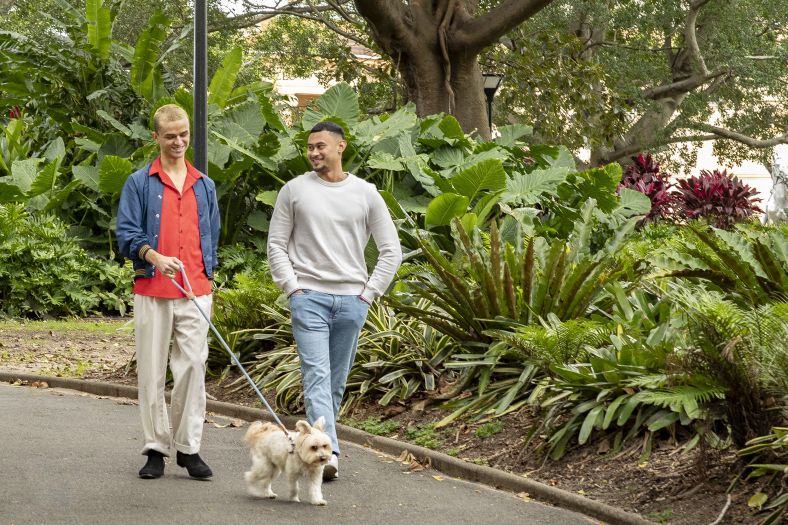 LQBTQ Male Couple walking a Dog at Park