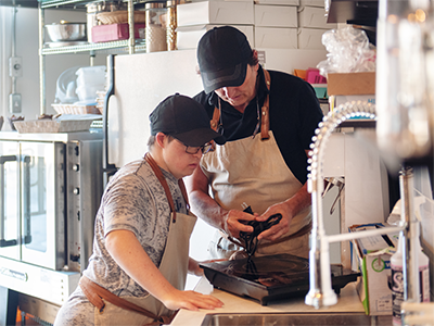 2 staff in kitchen during training session