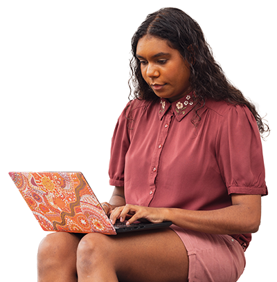 Women sat on bench working on laptop