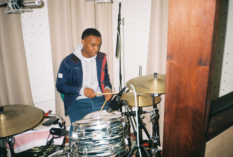 Multi-instrumentalist, producer and singer-songwriter Stevan in the recording studio. Stevan is playing the drums. 