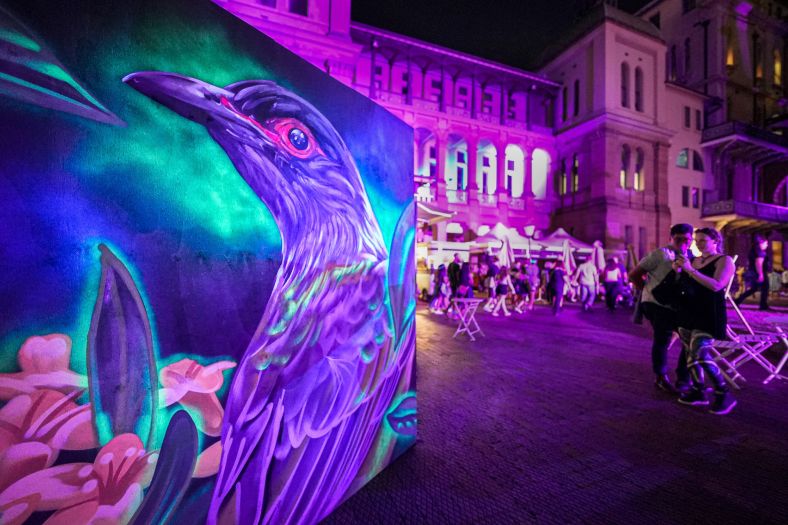 People attending an evening festival in Macquarie Street East