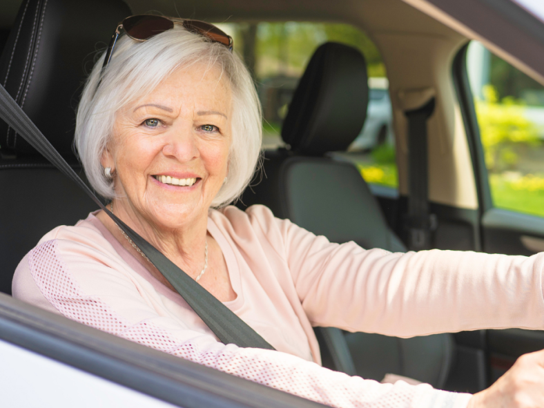 female volunteer transport driver behind the steering wheel