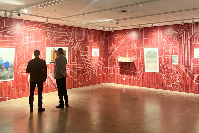 Two men stand together in front of art at Lismore Regional Gallery