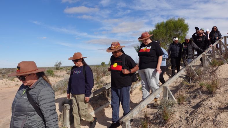 A group of Aboriginal women walk down stairs during their Cultural tour of Wiradjuri Country