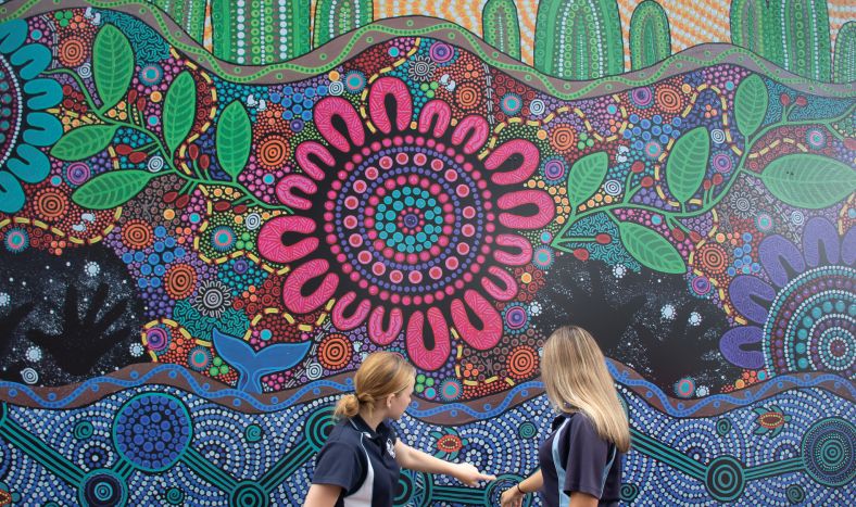 Eden Marine High School students with mural artwork they helped create.