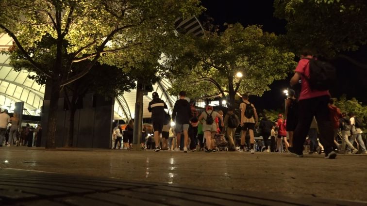 A crowd of people head to Sydney Olympic Park station.