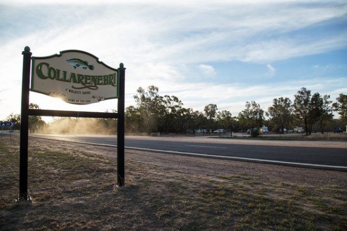 Collarenebri welcome sign on the side of the road at sunset