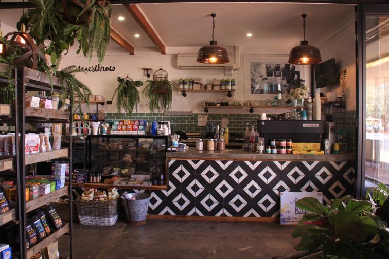 cafe interior with blue and white tiles and barista