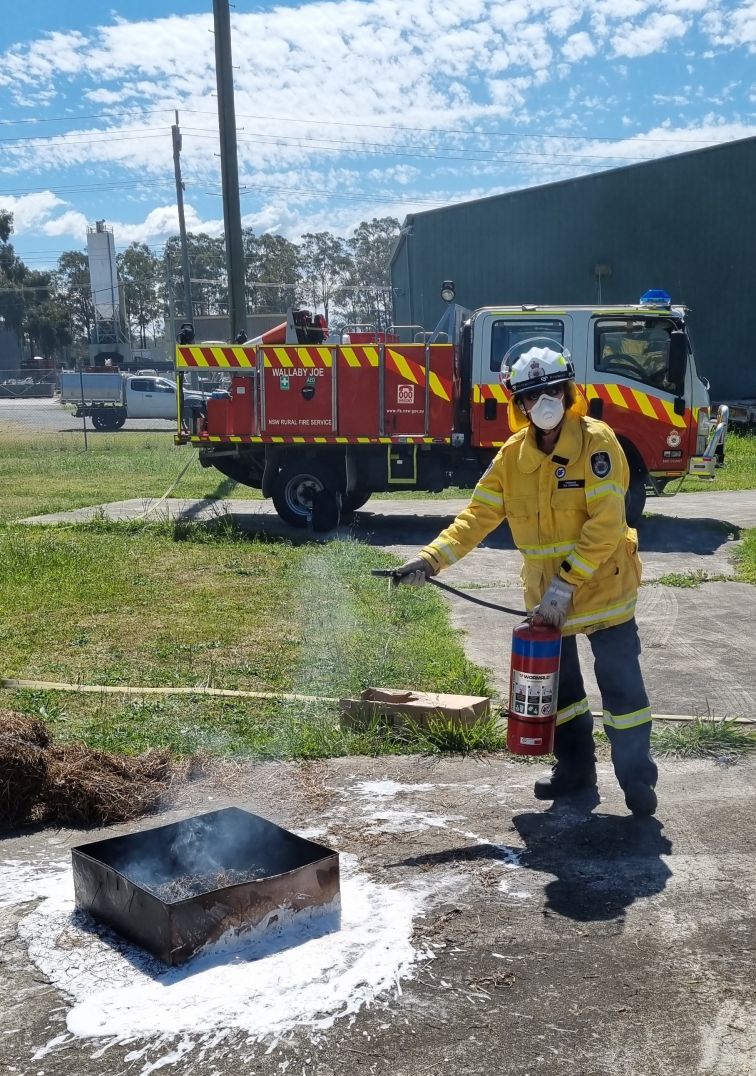 Female SES Volunteer extinguishing fire.