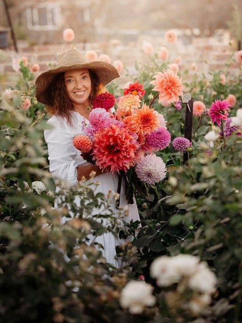 Woman in field holding flower bouquet 