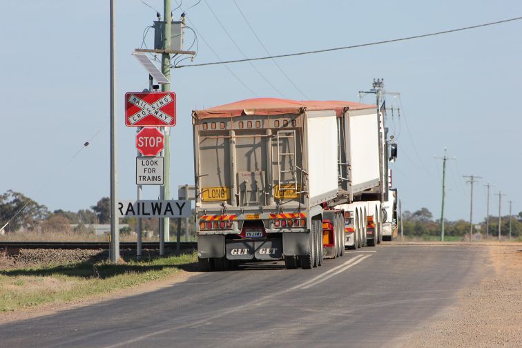 A truck crosses railway tracks at a level crossing in Narromine, that has had smart signage with LED lights installed.