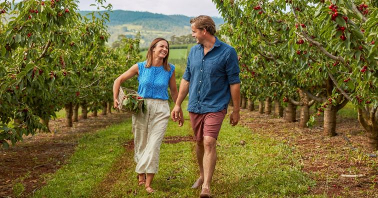 two people walking through vineyard in Orange