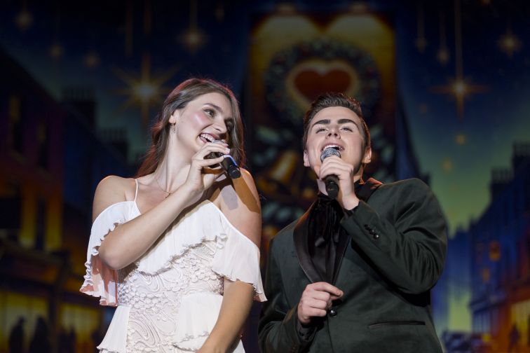 Will Skarpona and Stefanie Jones singing on stage