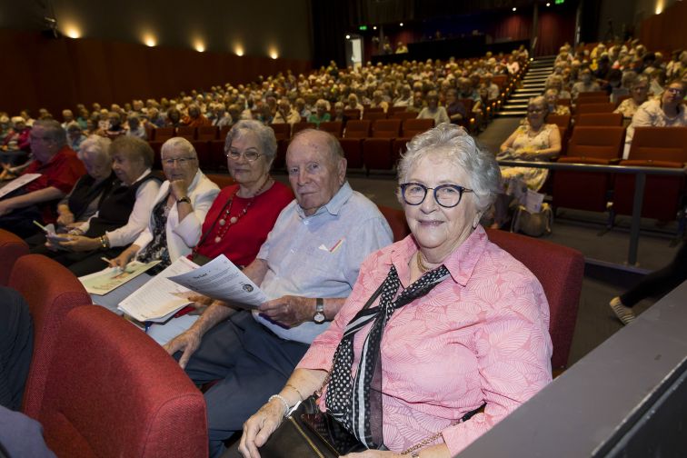 Seniors in audience smiling to camera