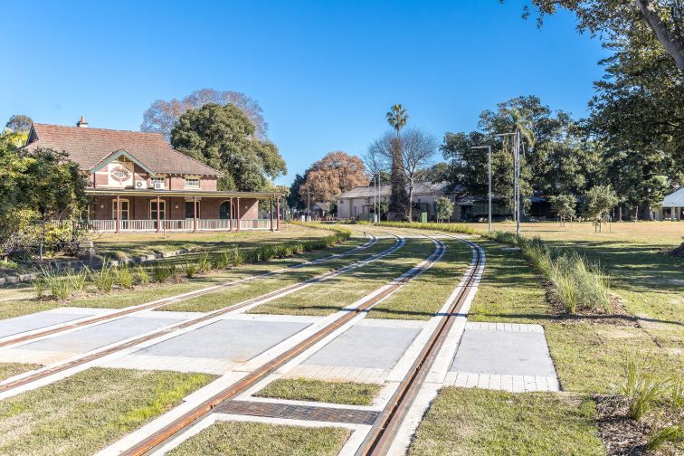 A shot of the Parramatta Light Rail 'Green track' going past Cumberland Hospital Precinct. 