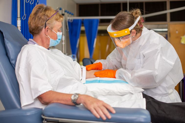 Gowned up nurse with patient