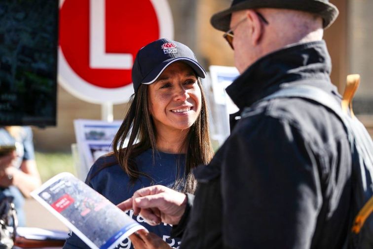 A Transport for NSW employee sharing information about the Parramatta Light Rail with a community member.