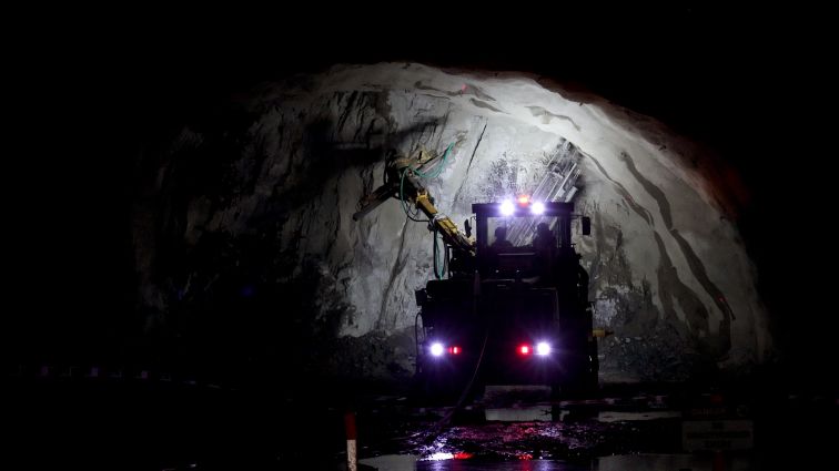 A large truck parked inside a dimly lit tunnel.