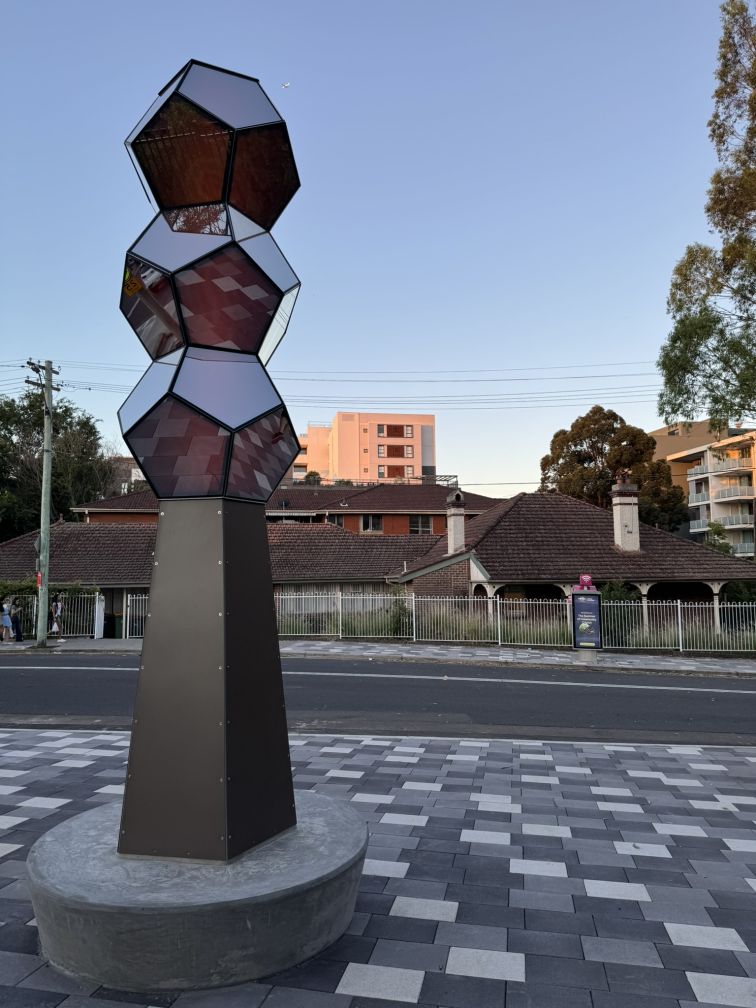 large urban sculpture with mirrored surfaces