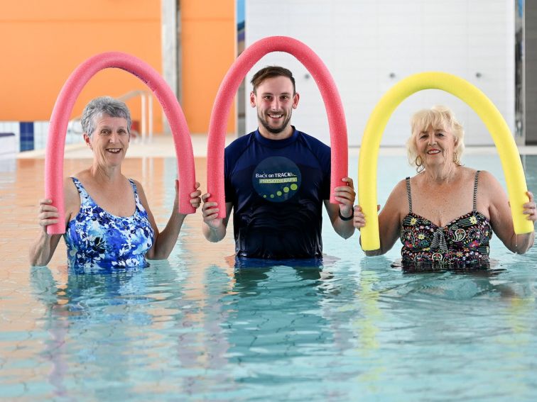 25m pool physiotherapy with noodles over head