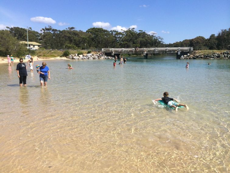 families enjoying the shallow clear waters