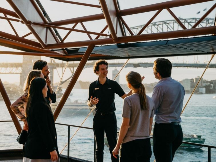 Tour guide showing group of people the Opera House