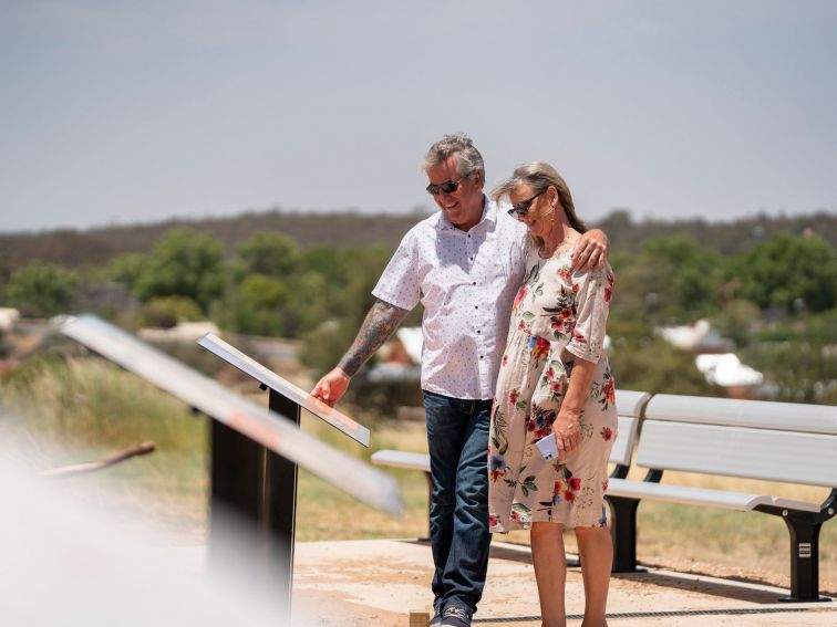 A couple walking the Narrandera Water Tower Art Trail