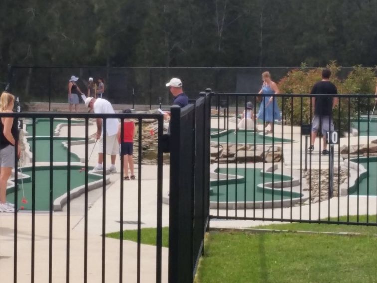 Some holidayers enjoying a round of mini golf