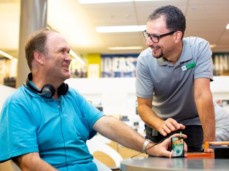 A librarian chatting with a visually impaired customer