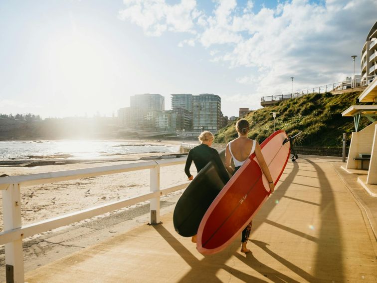 Surfers on Newcastle Beach