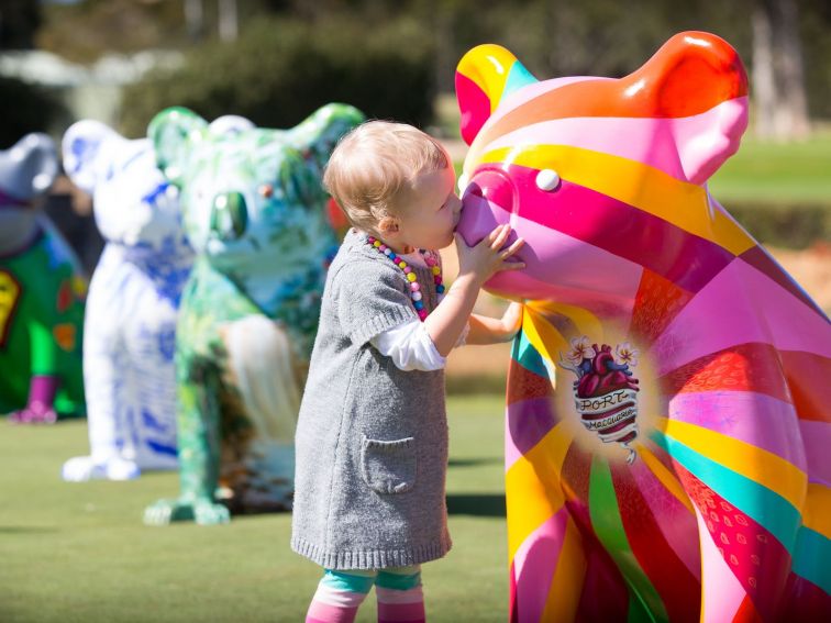 Jemma is kissing the Hello Koalas sculpture Radiant Heart on the nose